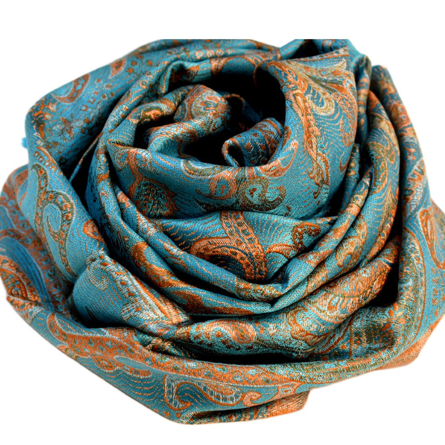 Turquoise and orange patterned scarf rolled up on a white background