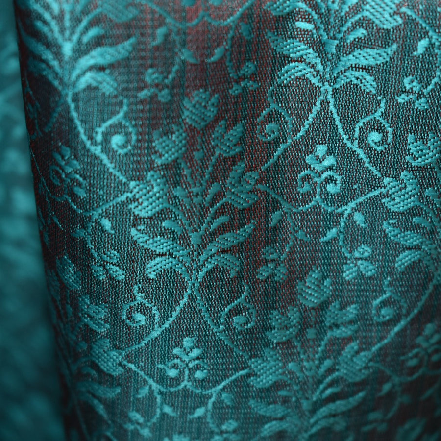 Close-up of teal fabric with intricate pattern