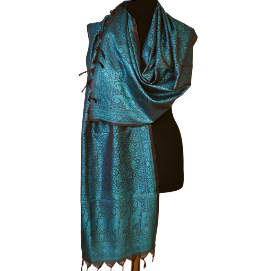 Teal patterned scarf on a black mannequin against a white background