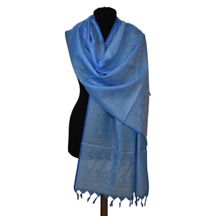 Blue scarf with fringe on a mannequin against a white background