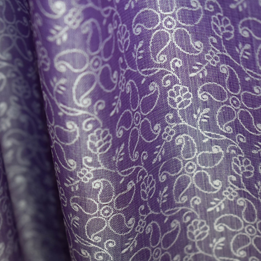 Close-up of purple fabric with white floral pattern