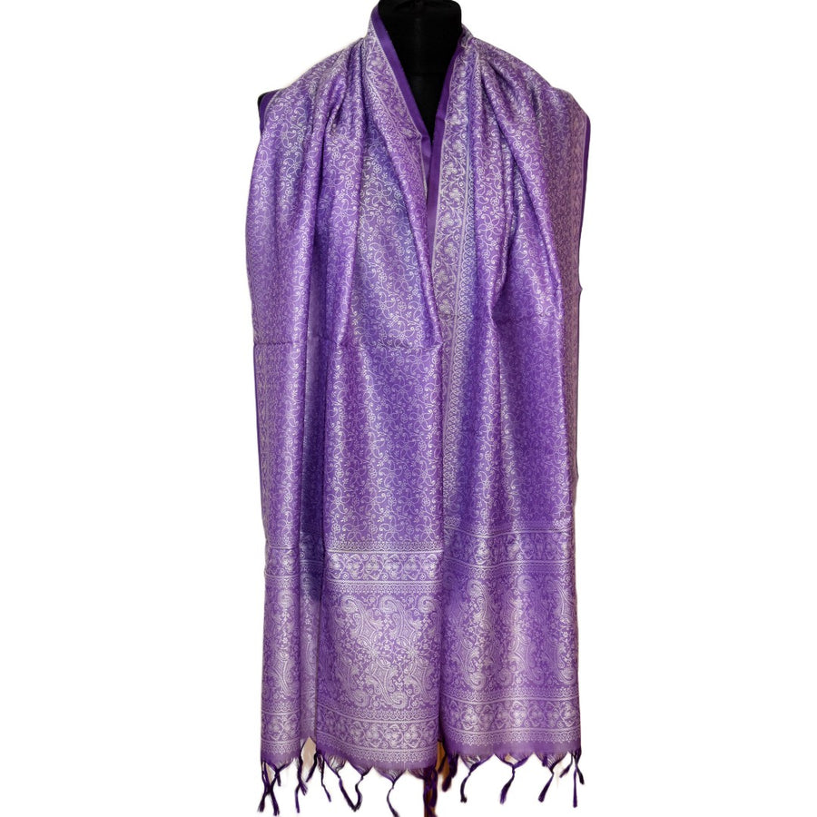 Purple scarf with intricate patterns on a mannequin against a white background