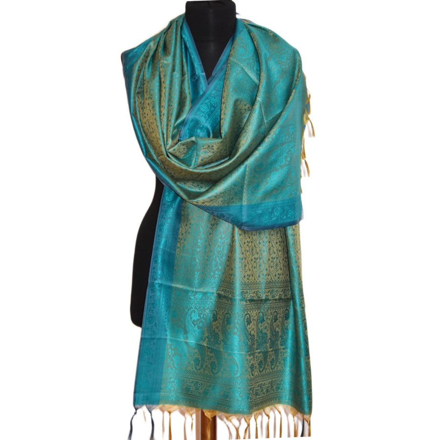 Turquoise scarf with intricate patterns on a mannequin against a white background