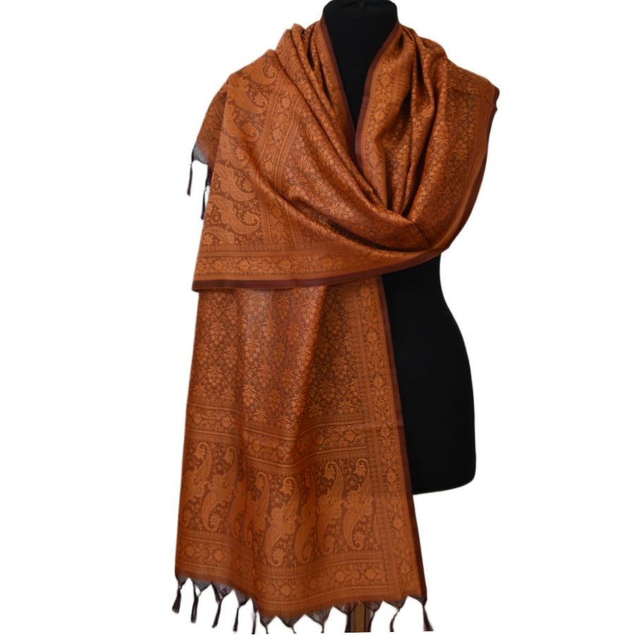 Brown patterned scarf on a black mannequin against a white background