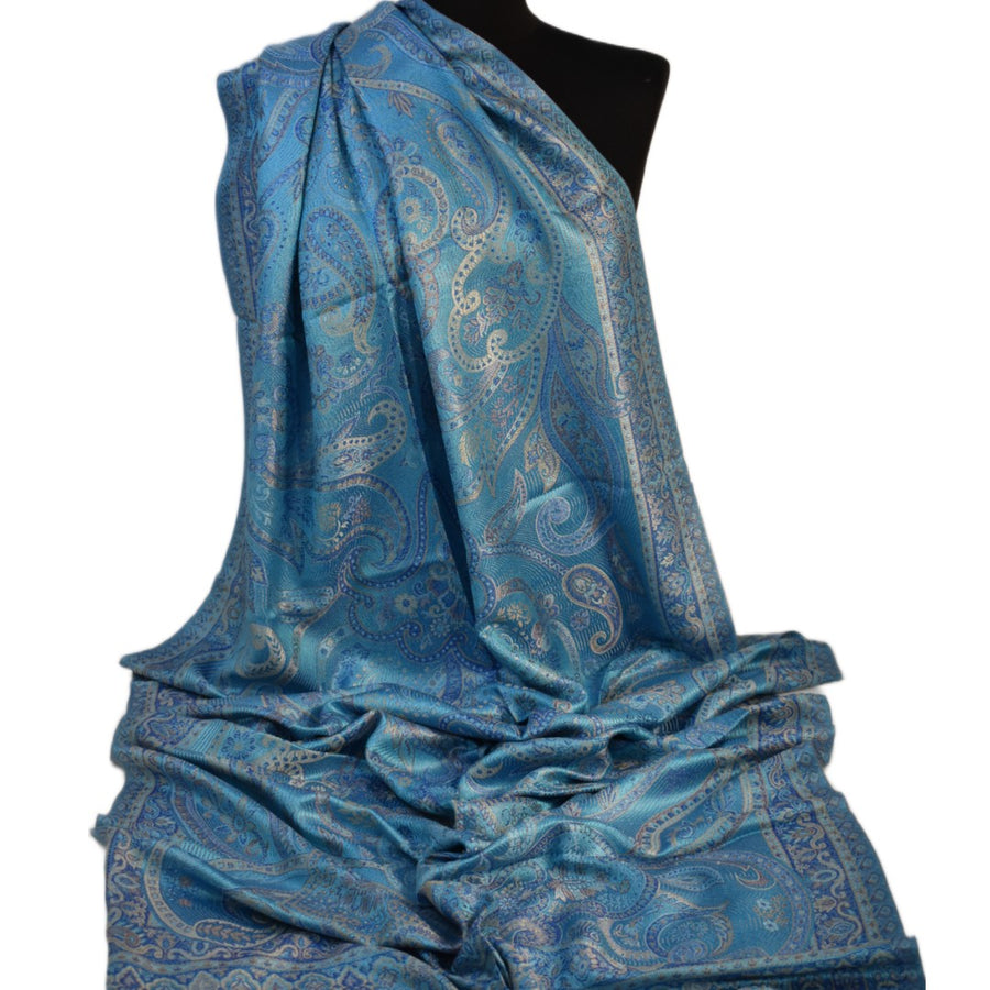 Blue paisley silk scarf on a mannequin with a white background