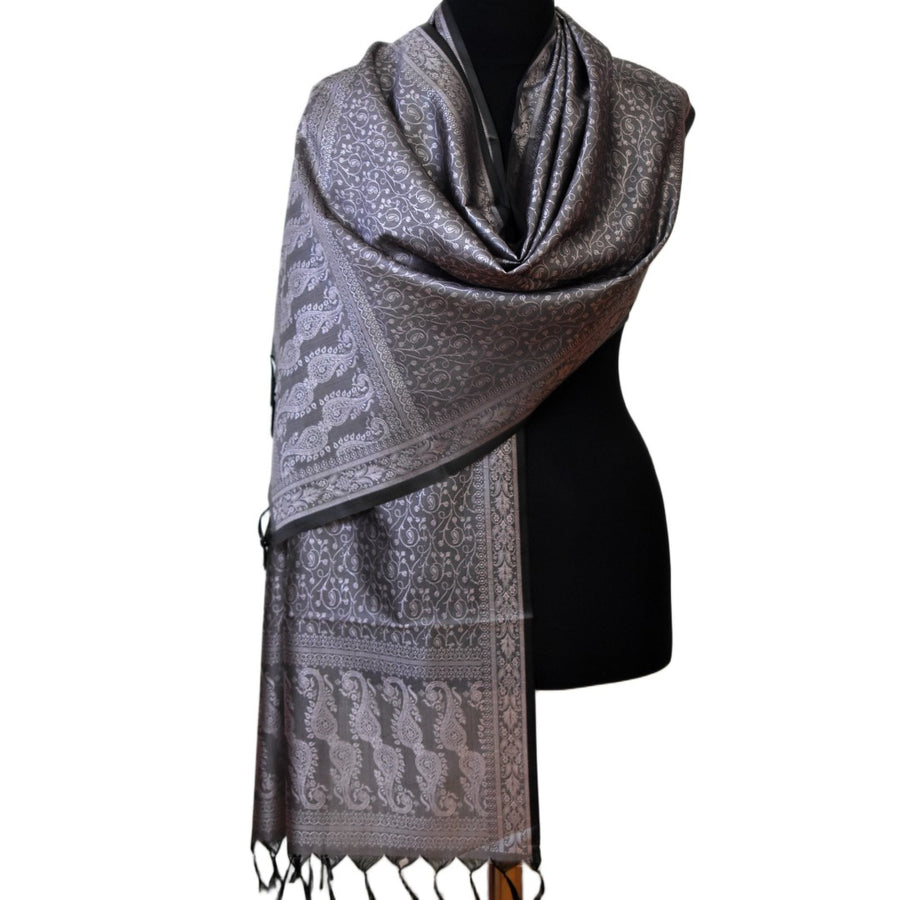 Gray patterned scarf on a mannequin against a white background