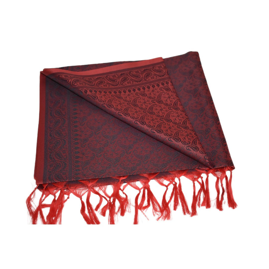 Red scarf with intricate patterns and fringes on a white background