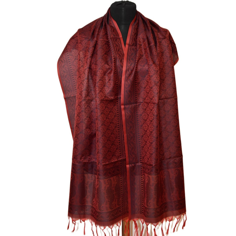 Red patterned scarf on a mannequin against a white background