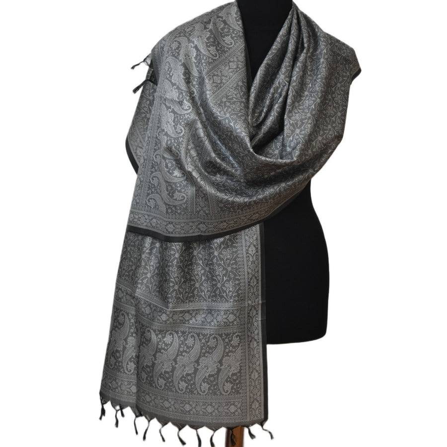 Gray patterned scarf on a mannequin against a white background
