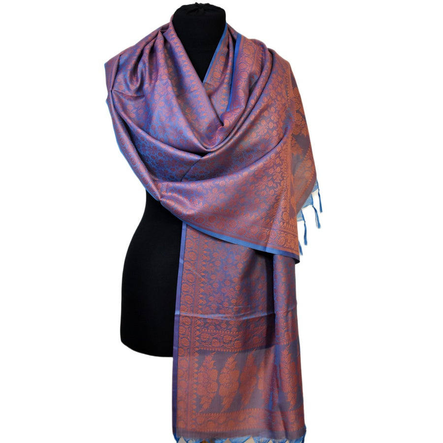 Patterned scarf draped over a mannequin on a white background
