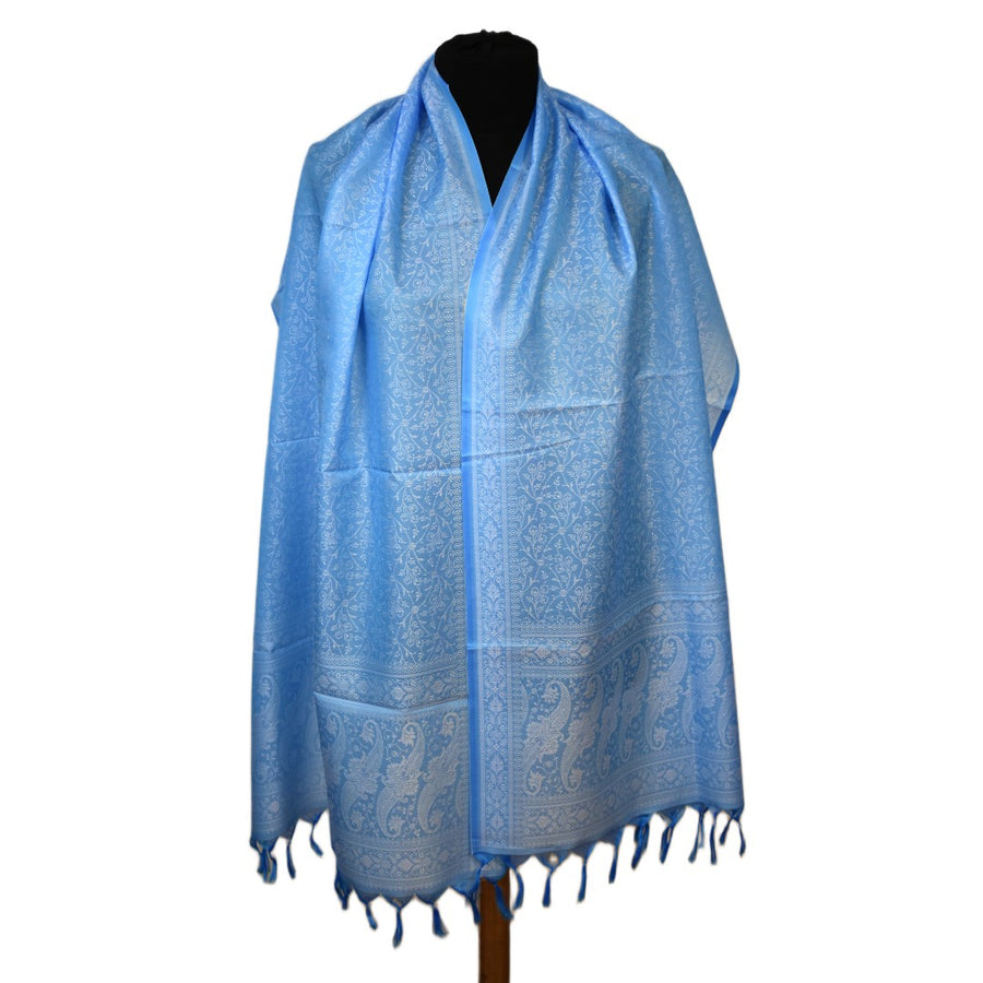 Blue patterned scarf on a mannequin against a white background
