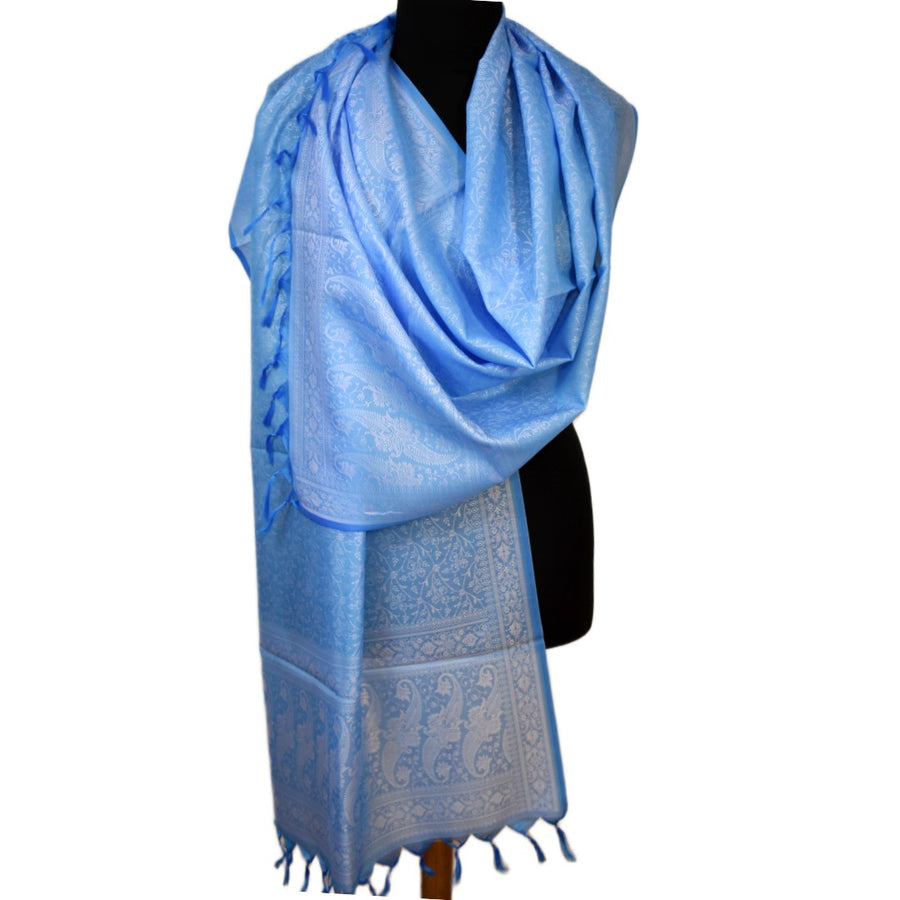 Light blue scarf with intricate patterns draped over a black mannequin on a white background