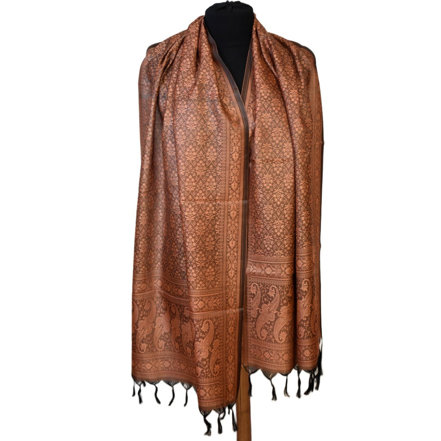 Brown patterned scarf on a mannequin against a white background