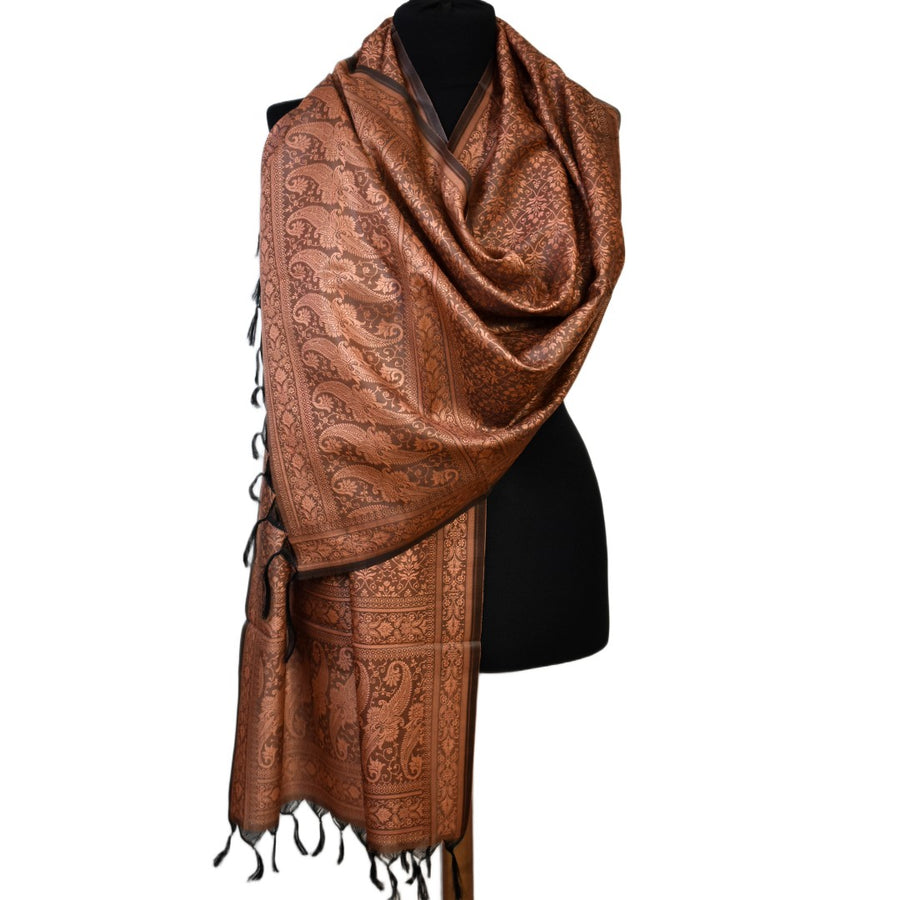 Brown patterned scarf on a black mannequin against a white background