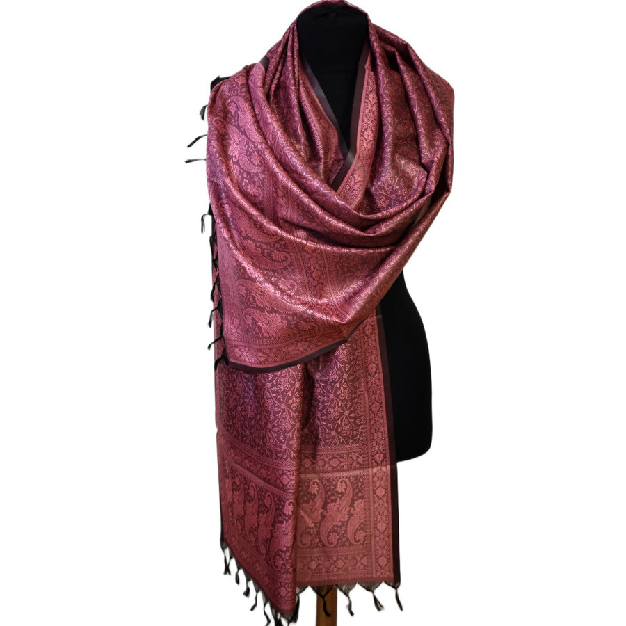 Red patterned scarf on a black mannequin against a white background