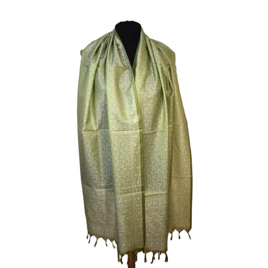 Green patterned scarf on a mannequin against a white background