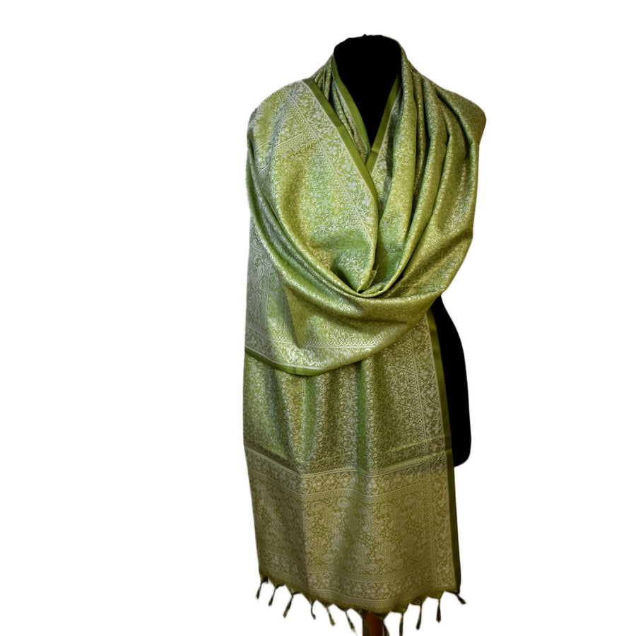 Green patterned scarf on a mannequin against a white background
