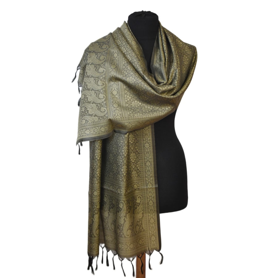Green patterned scarf on a black mannequin against a white background