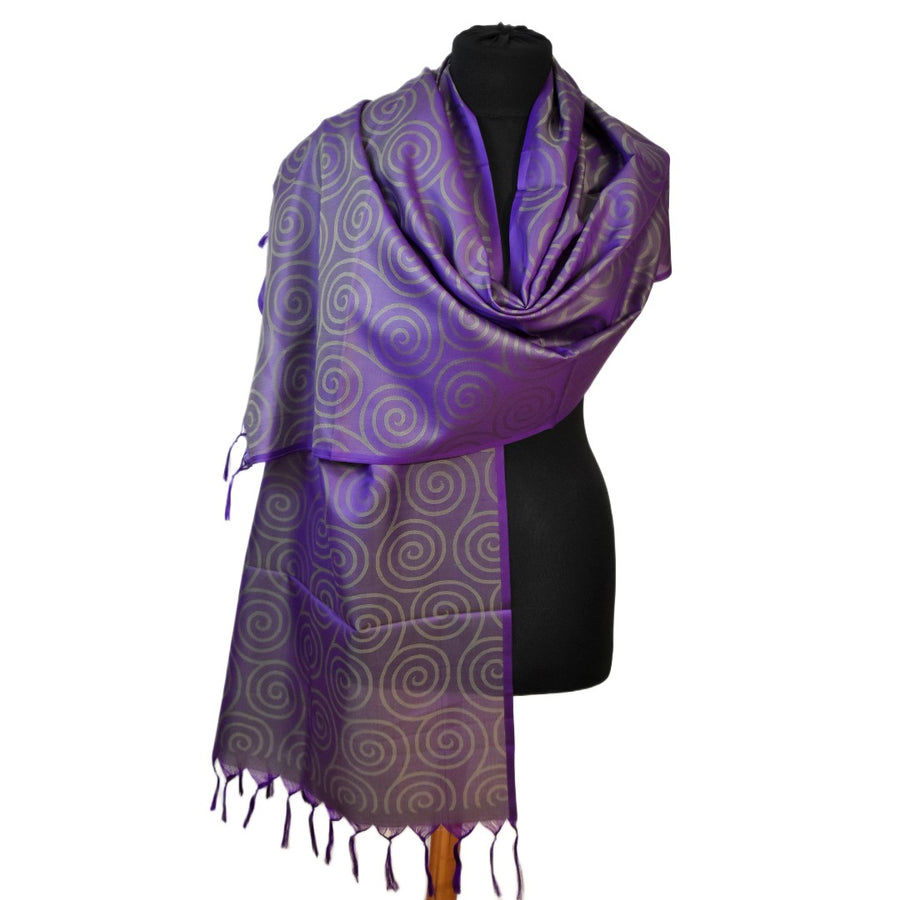 Purple patterned scarf on a mannequin against a white background