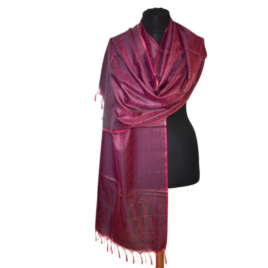 Red scarf on a black mannequin against a white background