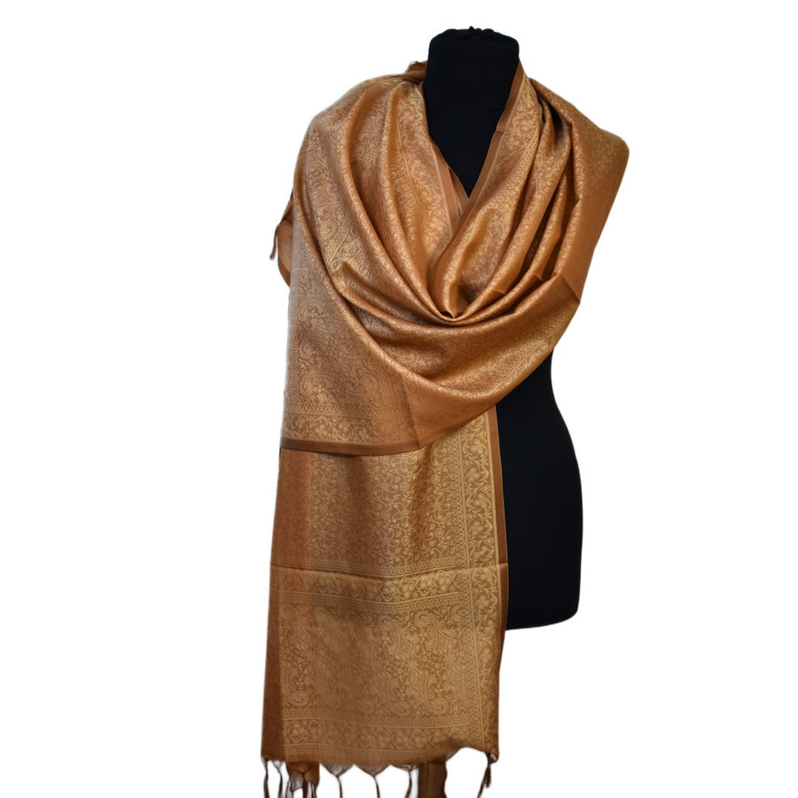 Brown scarf on a black mannequin against a white background