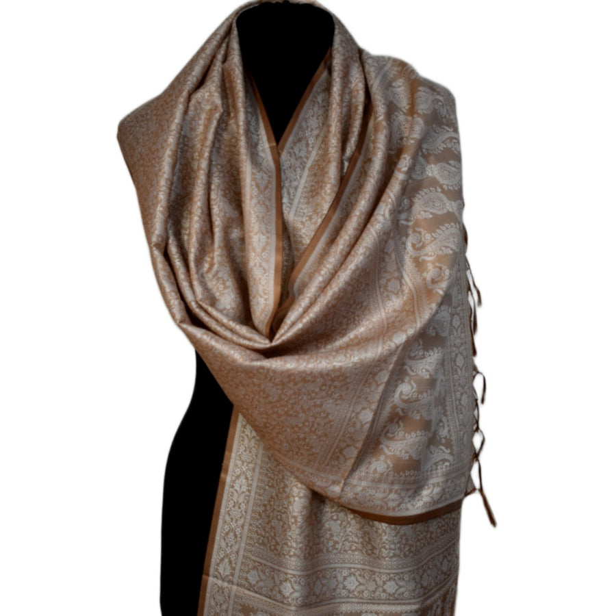 Beige patterned scarf on a black mannequin against a white background