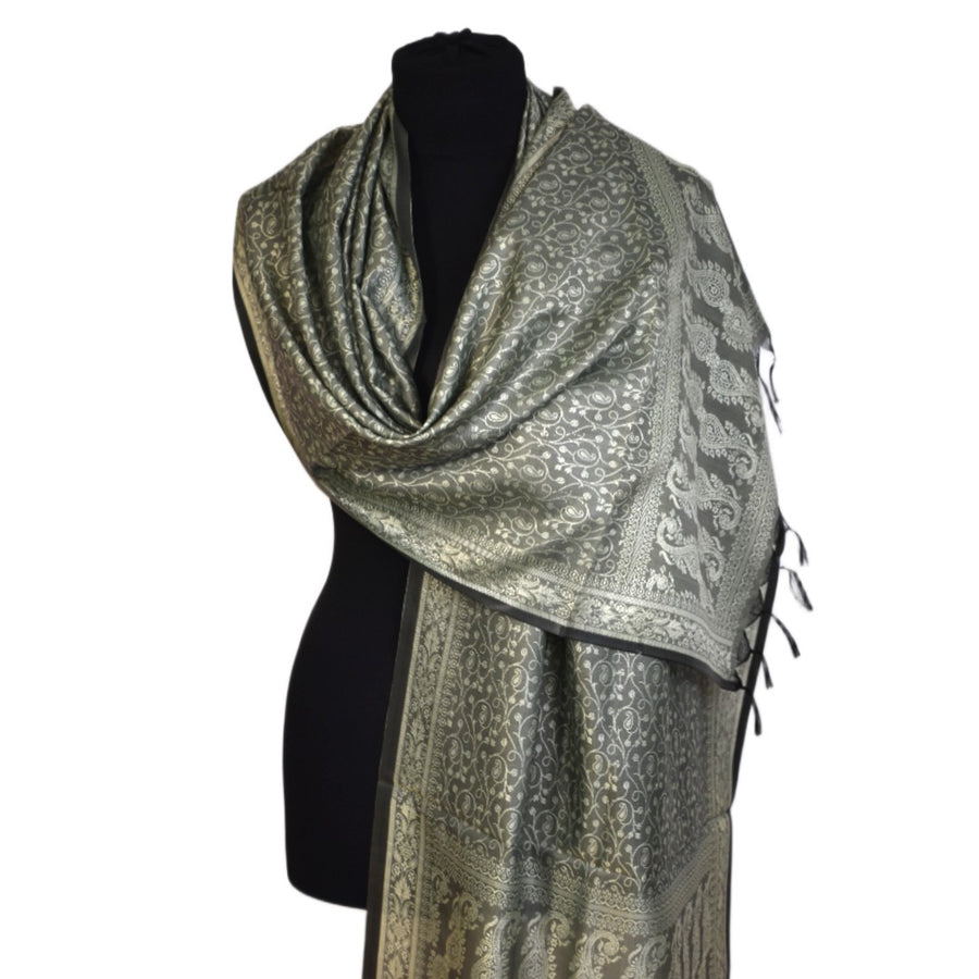 Patterned scarf on a black mannequin against a white background