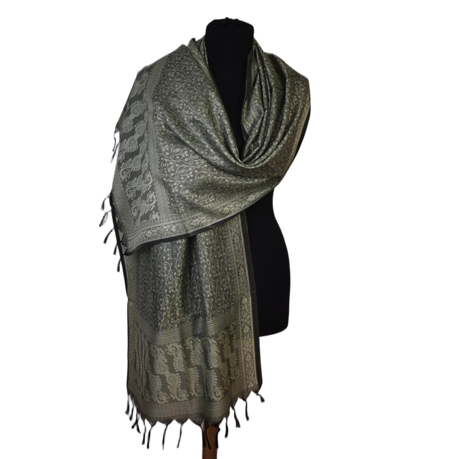 Gray patterned scarf with fringe on a mannequin against a white background