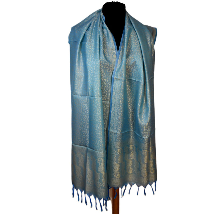 Blue patterned scarf on a mannequin against a white background