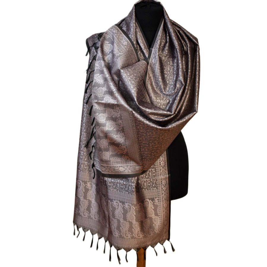 Patterned scarf with tassels on a mannequin against a white background