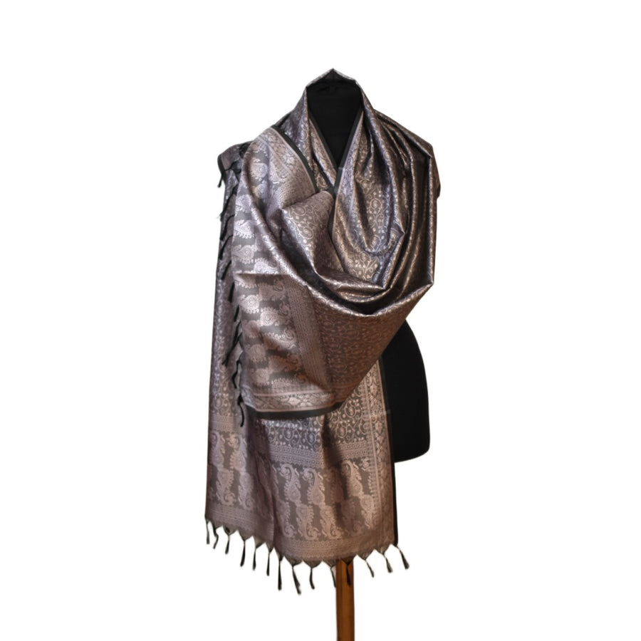 Bronze patterned scarf with fringe on a mannequin against a white background