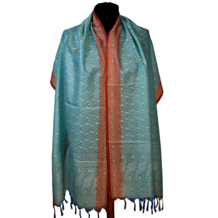 Teal and orange patterned scarf on a mannequin with a white background