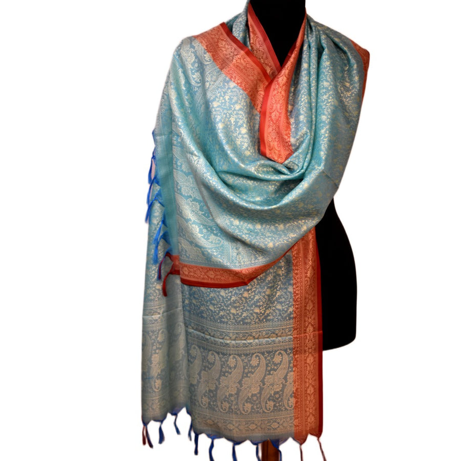 Light blue and orange patterned scarf on a mannequin against a white background